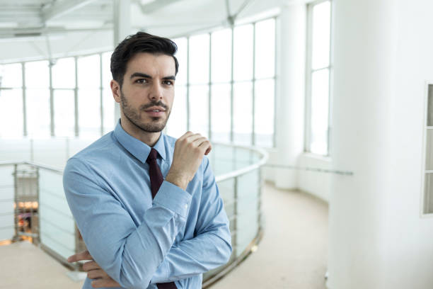 istock Businessman standing arms crossed in workplace 1012526048