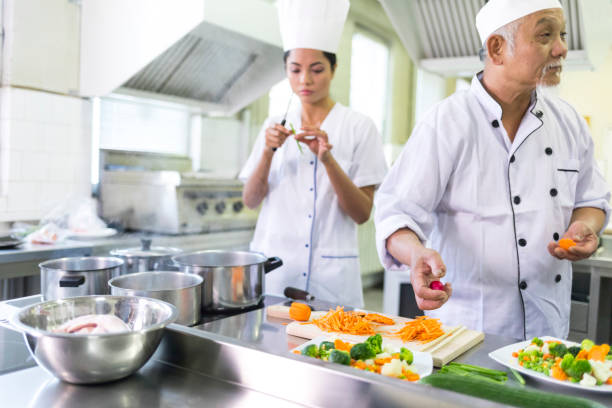 istock Chef and assistant cooking in restaurant 1012526218