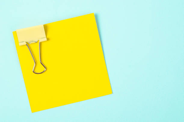 istock yellow binder clips and yellow sticky notes 1012526264