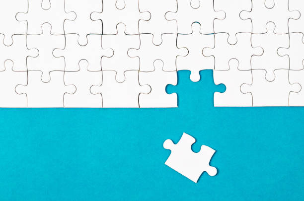 istock White puzzle pieces and place on blue 1012526886