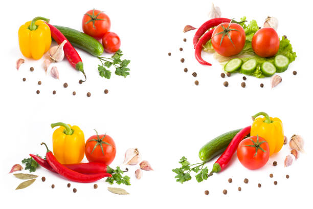 A composition of multi-colored vegetables on a white background. Fresh red tomatoes with yellow and red peppers on a white background. Red tomato with yellow and red bell pepper. Bitter pepper with green cucumber and red tomatoes and on a white background.