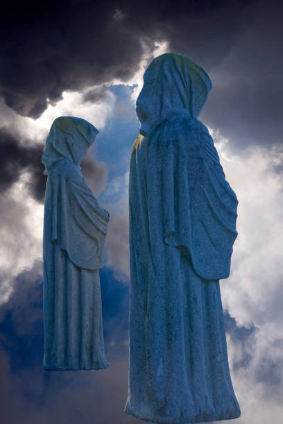 istock two faceless monk statues against dark skies 1012534864