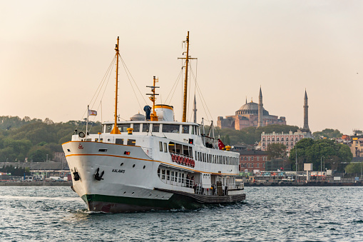 Istanbul, Turkey - April 15, 2023: A picture of a Cruise Ship docked on the Galataport, part of the Beyoglu district, with high rises on the right side.