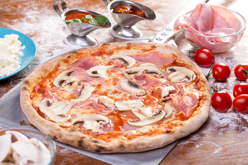 close up of appetizing mushroom and ham pizza