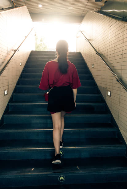 istock Woman walking up stairs 1012542080