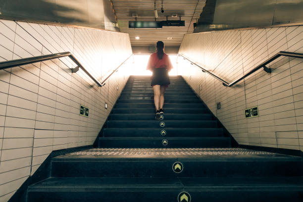 istock Woman walking up stairs 1012542094
