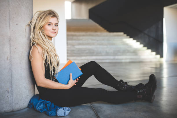 istock Woman relaxing at university campus 1012551432