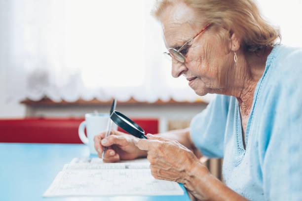 istock Senior woman enjoys solving a crossword puzzle 1012558382