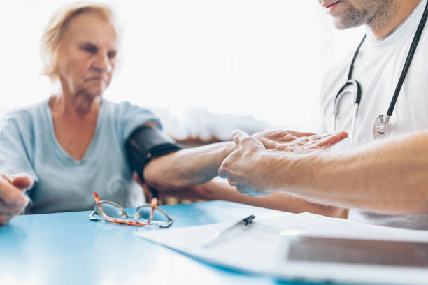 istock Senior woman during a medical exam with practitioner 1012558500