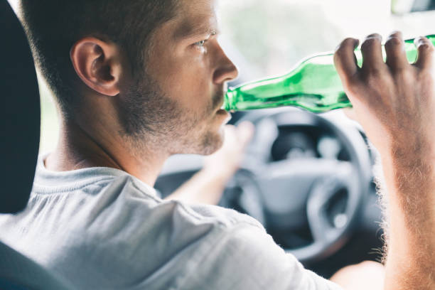 istock Drunk driver behind the steering wheel of a car 1012558734