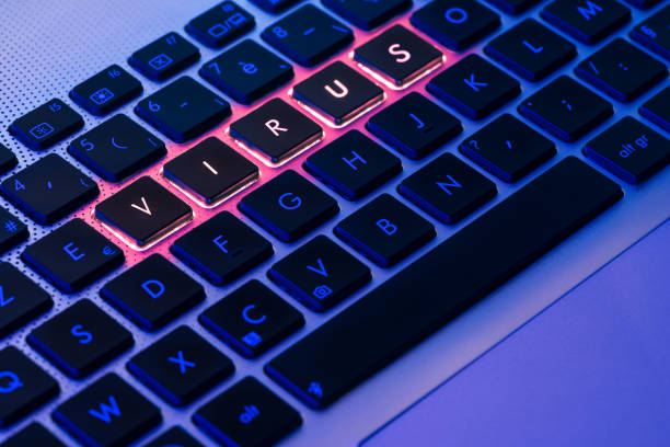 istock Virus written in red on a backlit keyboard in a blue ambiant light 1012561792