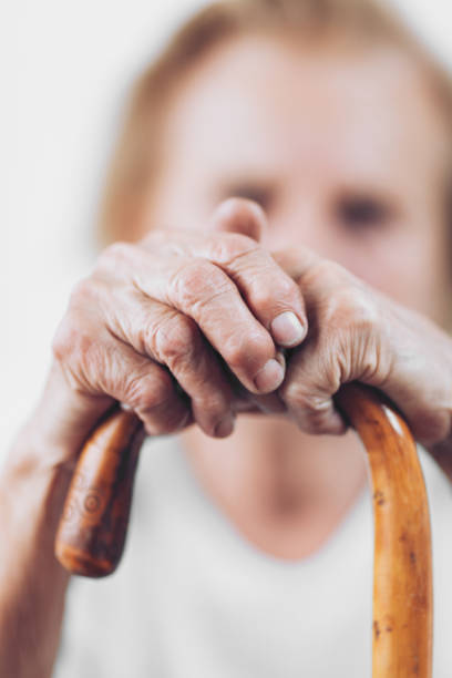 istock Elderly woman with a walking stick 1012562352
