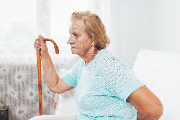 istock Elderly woman with a walking stick 1012562402
