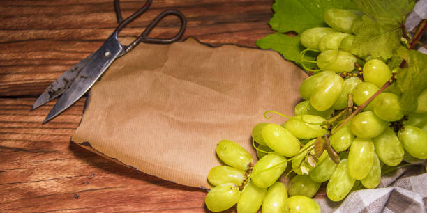 White grapes on rustic wooden background.