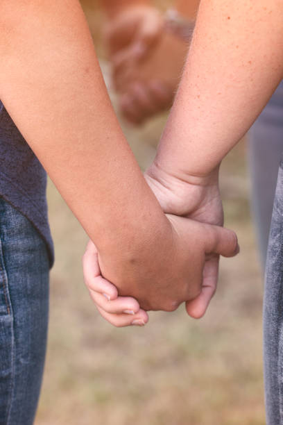 istock Group of People Praying in a Circle Holding Hands 1012569938