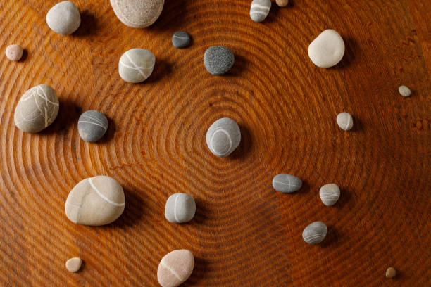 Pebble stones arranged on a wooden floor to a circular orbit
