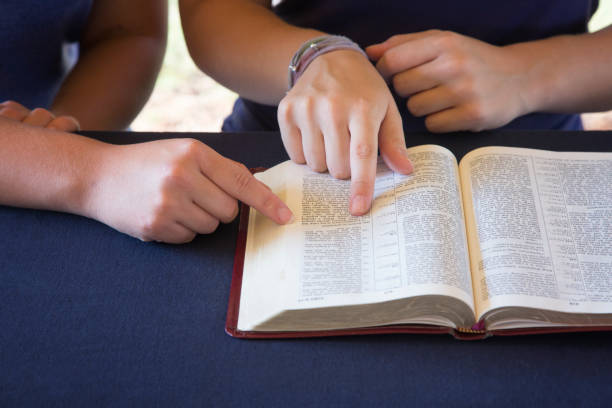 istock A Friend Helping Someone Study the Bible 1012580222