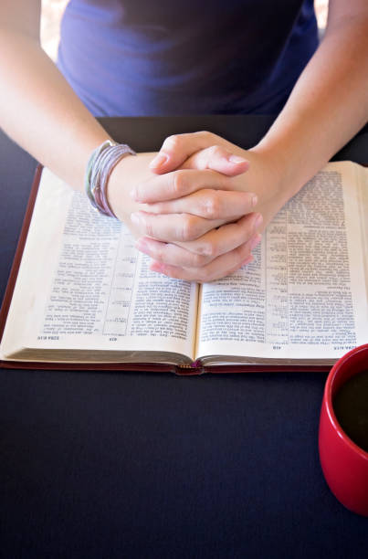 istock Young Person Studing the Bible and Praying 1012580224