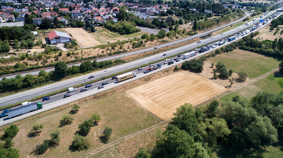Dense traffic and jam on German highway A3 during summer vacation time. Autoabahn A3 is a heavily frequented highway which connects the border to the Netherlands in the Northwest with the city of Passau in the Southeast of Germany. Aerial view