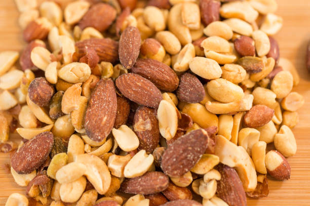 istock Background of nuts - pecan, macadamia, brazil nut, walnut, almonds, hazelnuts, pistachios, cashews, peanuts, pine nuts 1012581088