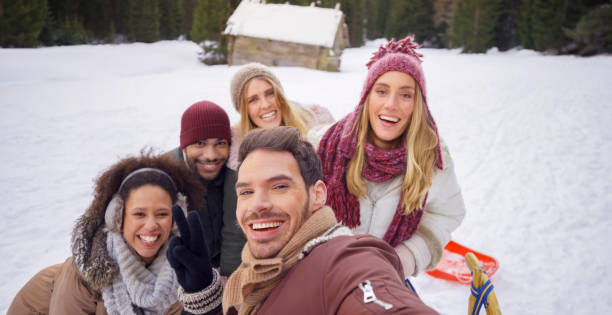 istock Friends taking selfie on snowy hill 1012585598
