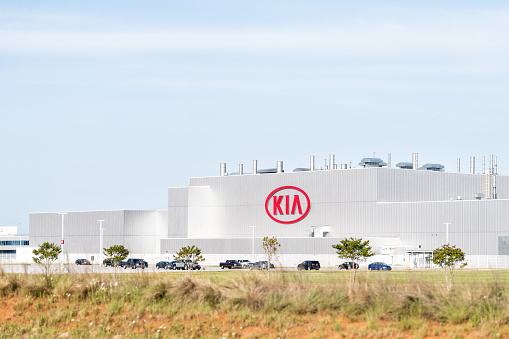 West Point, USA - April 21, 2018: Modern Kia Motors Manufacturing plant, factory, production, assembly facility in Georgia with sign, logo, cars