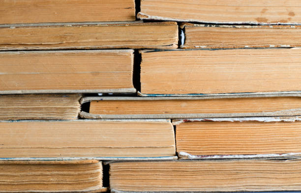 Old books with crumpled, torn covers.