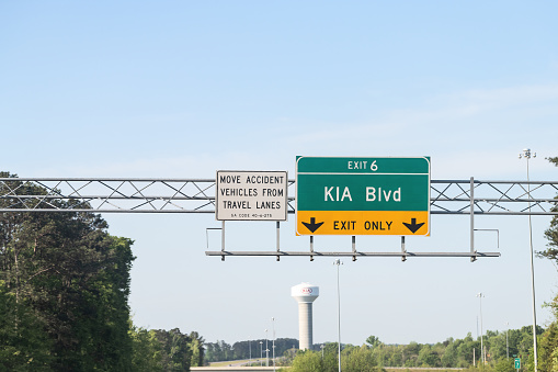 Langley, Canada - July 29, 2022: Traffic flows east on the tree-lined Trans-Canada Highway or Highway 1 near 200 Street in summer.