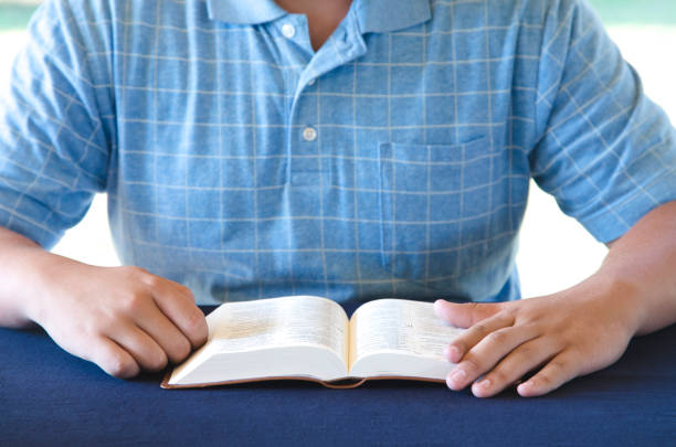 Young Person Studing the Bible and Praying