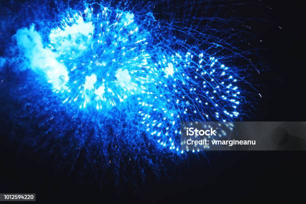 Amazing Fireworks Turquoise Flowers On The Night Sky Holiday Relax Time With A Pyrotechnic Show Brightly Fireworks On Dark Black Color Background Festive Event Accompanied By Holiday Salves Stock Photo - Download Image Now