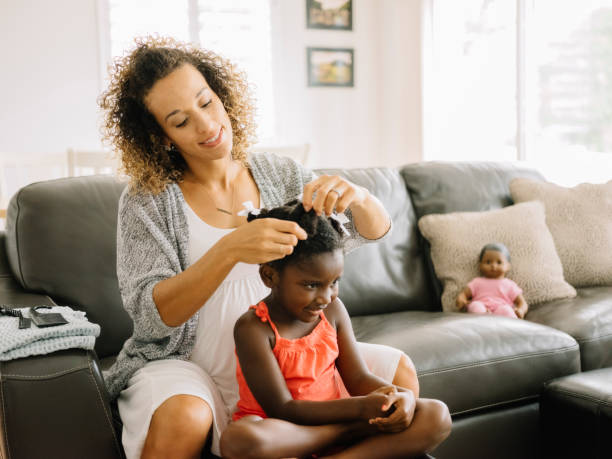 istock A Mother Doing Daughter's Hair 1012597390