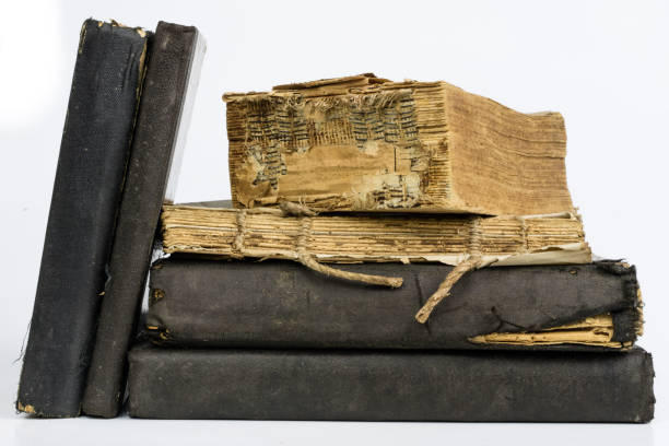 istock Old destroyed book on a white table. Old-style cover. White isolated background. 1012602644