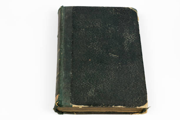 istock Old destroyed book on a white table. Old-style cover. White isolated background. 1012613246