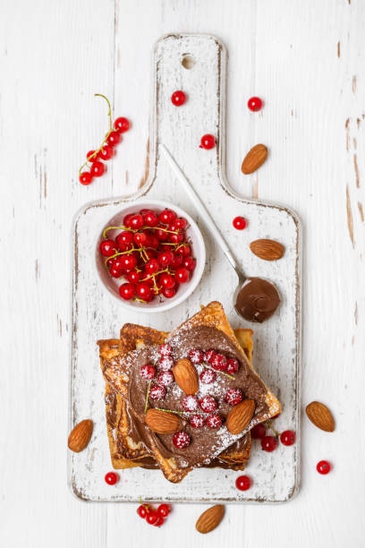istock stack of fried toast with chocolate cream, red currant and almon 1012613460