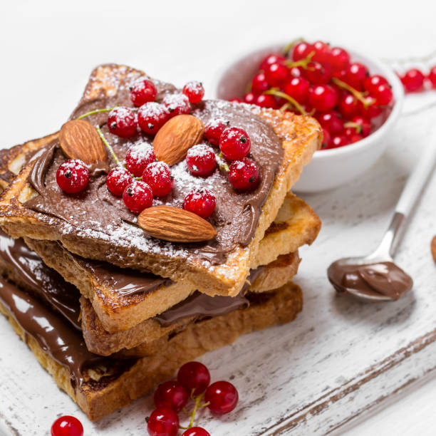 istock stack of fried toast with chocolate cream, red currant and almon 1012613468