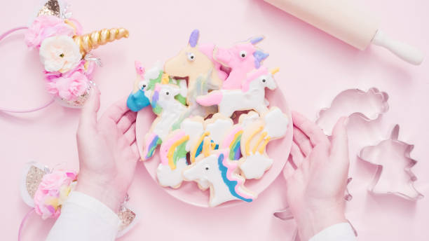 istock Unicorn shaped sugar cookies decorated with royal icing on pink plate. 1012618656