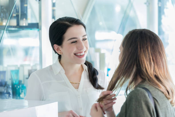 istock Friendly hairstylist assists female customer 1012625036