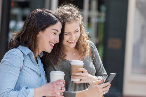istock Close friends look at something on smart phone 1012627220