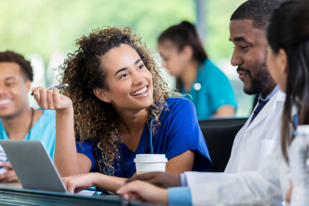 istock Cheerful medical student talks with classmates 1012627454