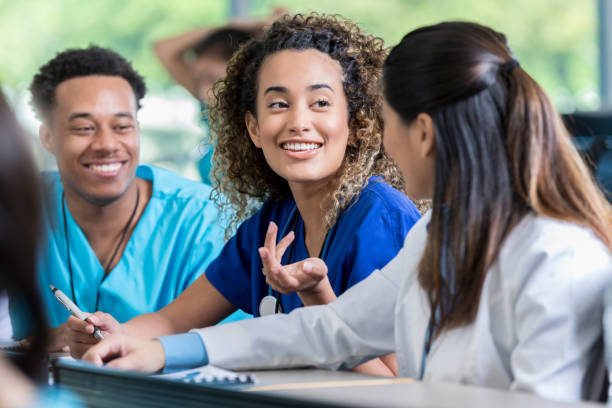 istock Cheerful nursing student talking with friends 1012627456