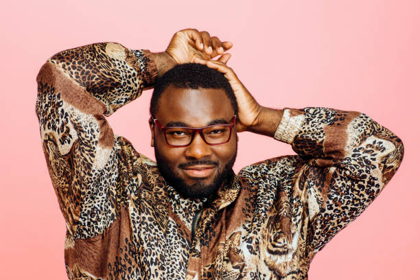 istock Handsome man with glasses, leopard print shirt and arms up, 1012628268