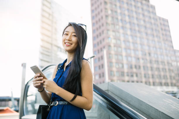 istock Businesswoman riding with escalator. 1012632286