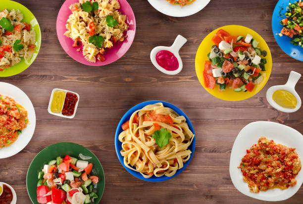 istock Pasta with vegetables and sauce on a table. Spaghetti on a plate. Mediterranean food. 1012644014
