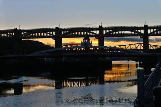 A sunset shot of the Tyne river in Newcastle looking over some of its many bridges in England, United Kingdom. Photograph taken in the Winter of 2017.