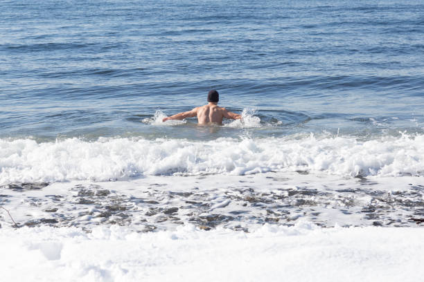 istock Man swimming in winter time 1012667374