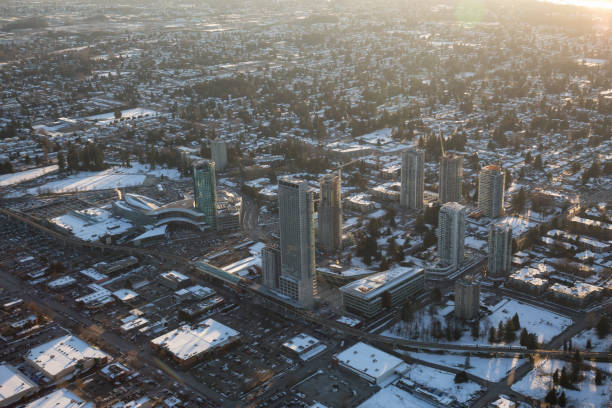 Surrey Central Vancouver, British Columbia, Canada - February 22, 2018: Aerial view of Surrey Central Mall and Residential Buildings during a vibrant winter sunset. surrey british columbia stock pictures, royalty-free photos & images