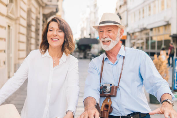 istock Smiling senior tourists with camera equipment 1012672120