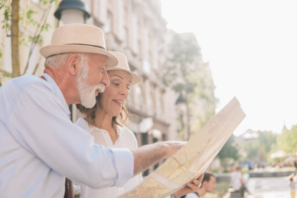 istock Elderly couple looking at the map and smiling 1012676826