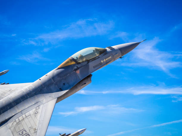 – February 15, 2022: A Luke airbase f16 military plane flying in the vibrant cloudy sky in Phoenix, Arizona