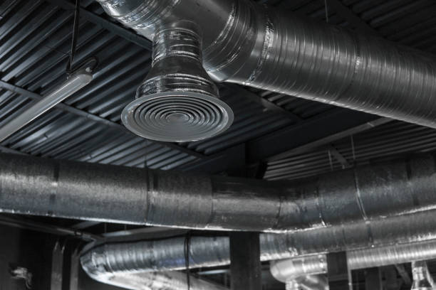 istock Ventilation system on the ceiling of large buildings. Ventilation pipes in silver insulation material hanging from the ceiling inside new building. 1012679736